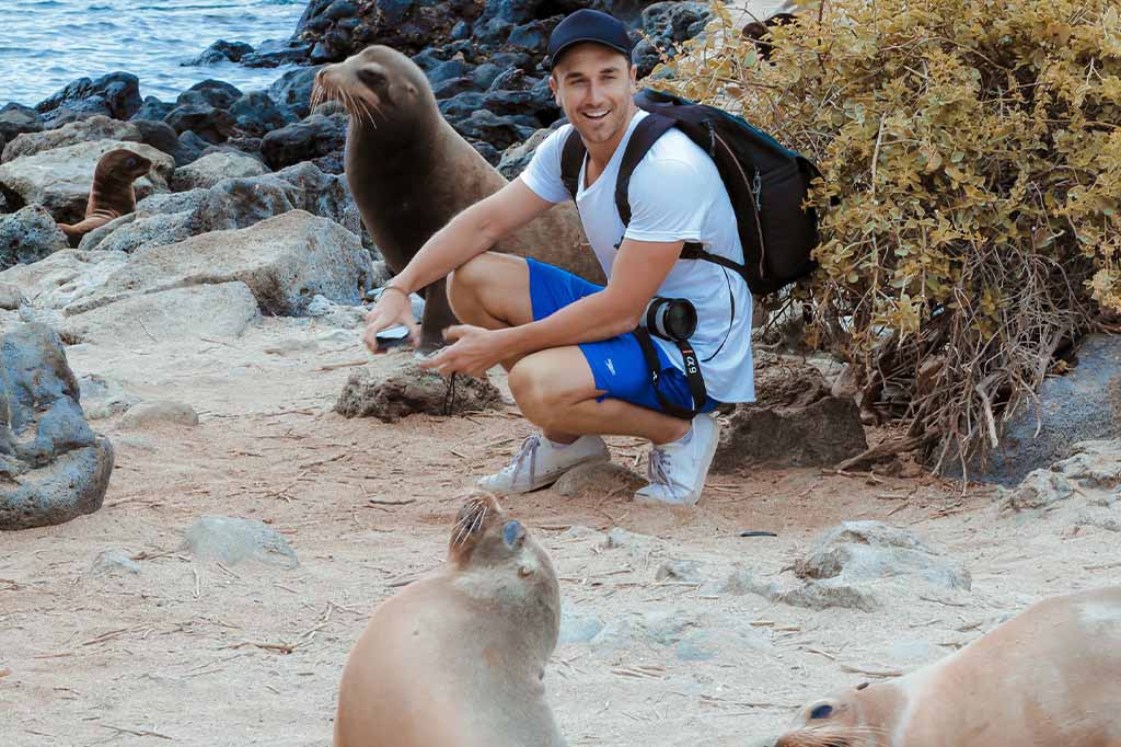 tourist with sea lion in galapagos